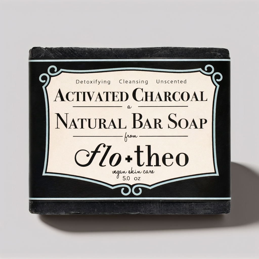 Bar of soap with 'Activated Charcoal' and 'Flo + Theo' branding on a gray background