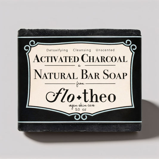 Bar of soap with 'Activated Charcoal' and 'Flo + Theo' branding on a gray background