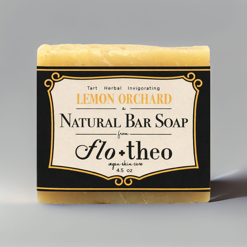 Bar of soap with 'Lemon Orchard' and 'flo + theo' branding on a gray background
