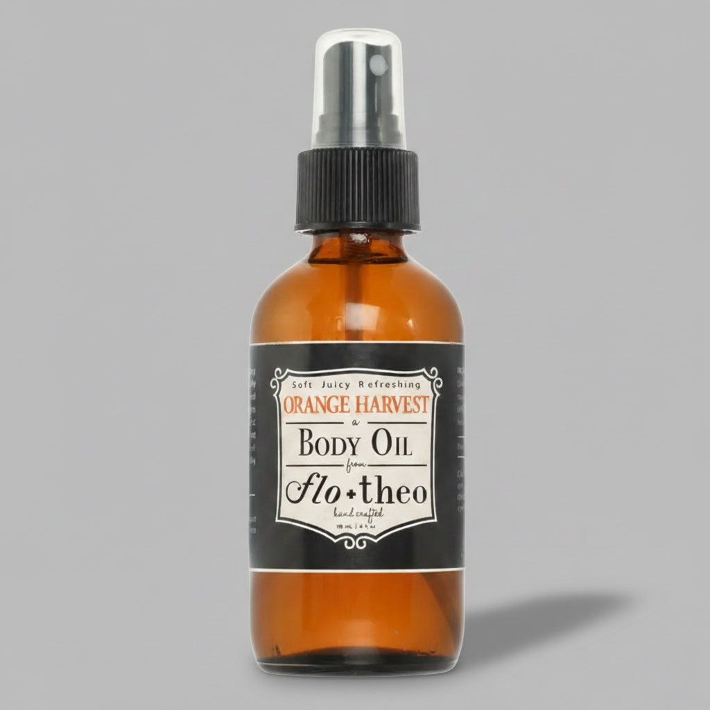 Brown bottle of 'Orange Harvest' body oil with a black label on a gray background